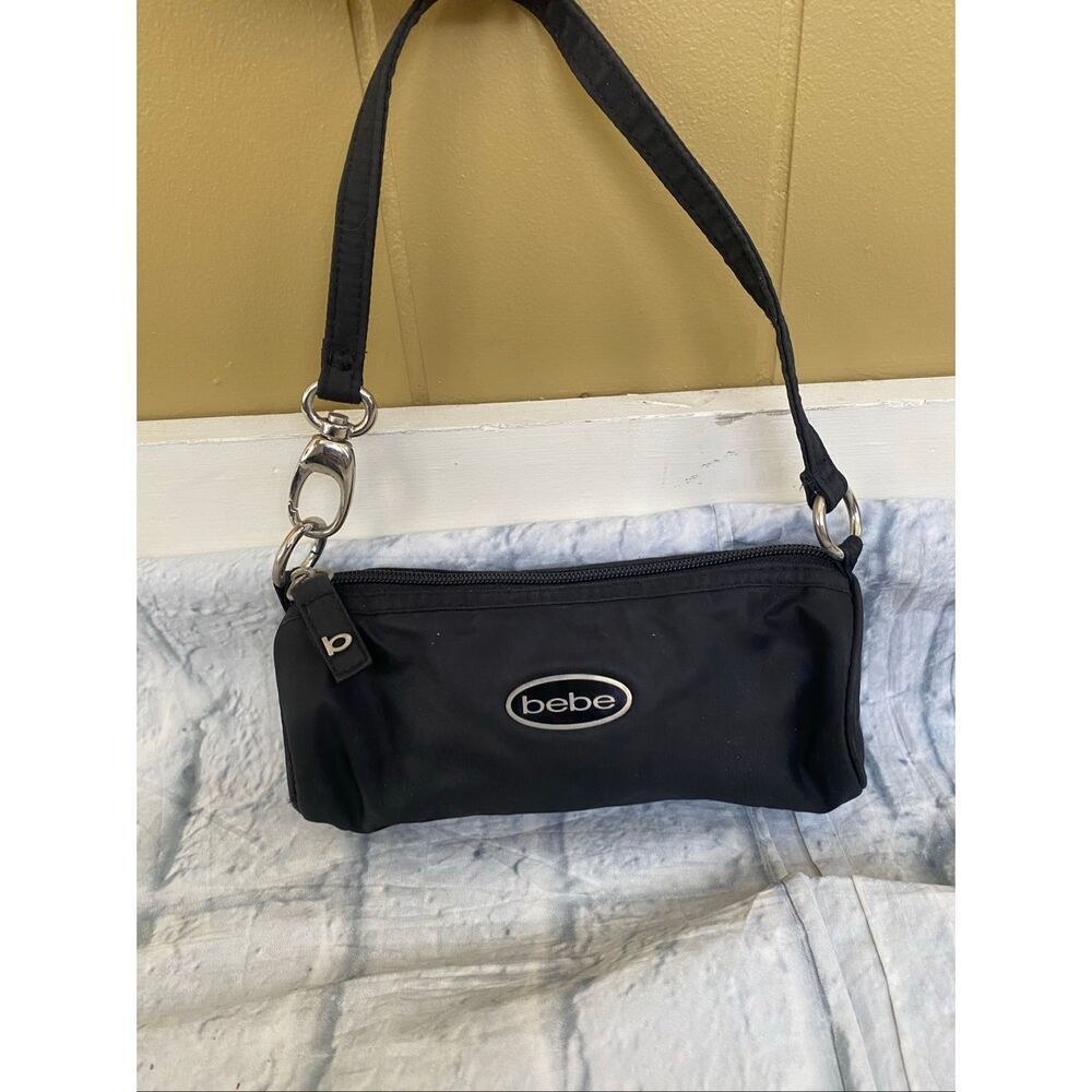 Bebe 8Lx3Wx5H mini barrel purse with satin lining and strap w/clasp